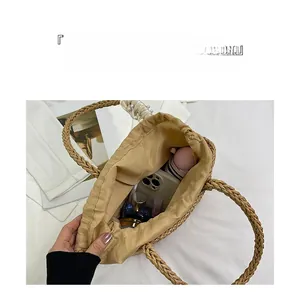 Spacious beige straw tote bag interior showing capacity for cosmetics and accessories