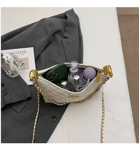 Detail of white quilted bag showing large capacity for phone, makeup, and umbrella