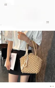 Detail showing handwoven texture with pearl ribbon and drawstring closure of the bucket bag