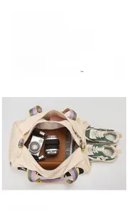 Spacious travel bag with shoe compartment for sneakers, headphones and camera storage