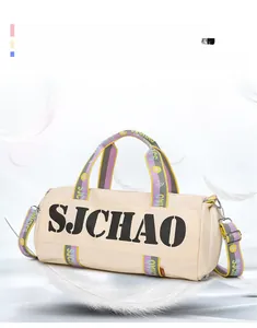 Detail view of cream travel bag with colorful woven straps and metal zipper hooks
