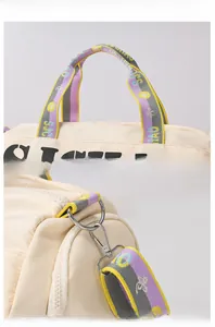 Detail of travel bag with colorful jacquard strap and silver metal hooks on nylon fabric