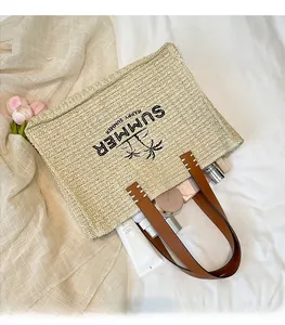 Interior view of straw tote showing spacious capacity with summer pattern details