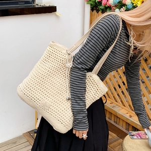 Detail of cream woven tote bag featuring mesh texture and leather drawstring handles