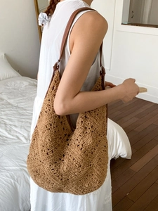 Borsa tote bohémien marrone lavorata a mano all'uncinetto con cinturini in pelle su modella