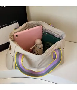 Detailed internal view of spacious nylon tote bag with organized storage and contrast strap