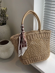 Hollow straw woven tote bag with a bear print scarf on handle for summer beach holidays