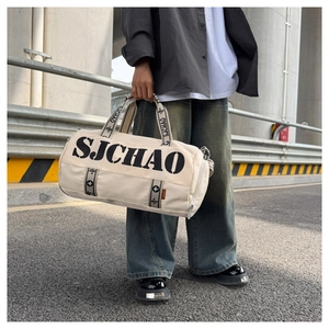 Close-up of beige travel bag with SJCHAO lettering and stylish black woven handles
