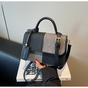 Detail of contrast-panel crossbody bag with woven texture and suede material