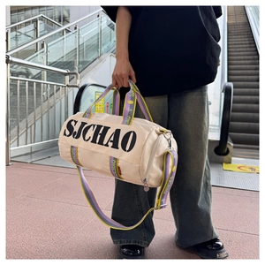 Detail of off-white travel bag with colorful woven straps and SJCHAO print