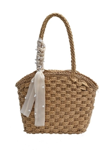 Natural woven straw tote bag with pearl-accented beige ribbon and long shoulder strap