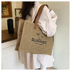 Macro view of woven straw texture and leather handles on summer tote beach bag