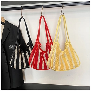 Mesh striped dumpling bags in red, black, and yellow displayed on a clothing rack
