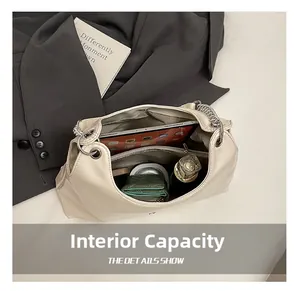 Detail view of large capacity beige tote bag showing internal compartments for daily storage