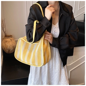 Detail view of yellow and white striped mesh tote bag featuring breathable woven texture