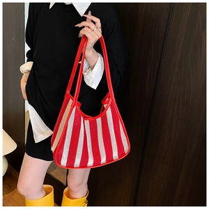 Detail of red and white striped mesh tote bag with durable faux leather handles