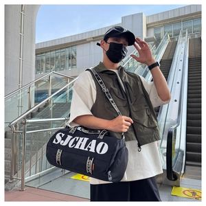 Close-up of lightweight black travel bag with SJCHAO logo and wide shoulder strap