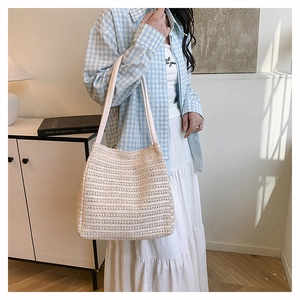 Detailed close-up of handmade woven tote bag with openwork texture and summer style