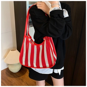 Detailed texture of red and white striped mesh fabric on a half-moon shoulder bag