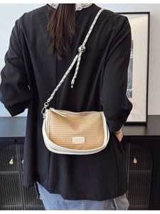Retro straw shoulder bag with white leather trim and chain strap displayed on a model