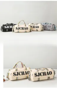 Detail of multi-color cylinder travel bags with SJCHAO lettering and adjustable straps