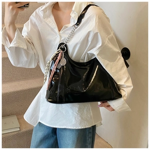 Black patent leather hobo bag with silver chain strap and tennis racket charm detail