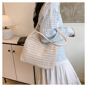 Minimalist woven tote bag showing detailed texture and strap in a modern home setting