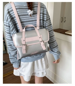 Detail of silver and pink contrast backpack with Aimaier metal lettering and buckle