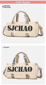 Detail view of large capacity travel duffel bags in off-white and purple contrast colors