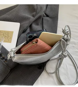 Silver crescent bag interior view showing storage space for phone and wallet