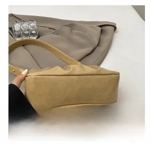 Detail shot of the wear-resistant base and textured leather of the cloud bag