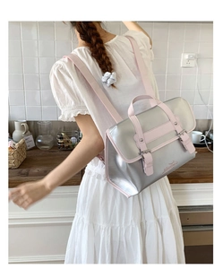 Detail of silver metallic backpack with pink straps and secure buckle closure