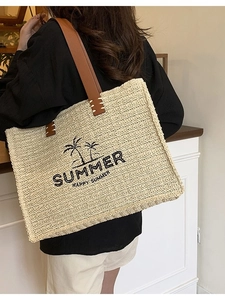 Large beige woven straw tote bag with brown leather straps and Summer palm tree embroidery