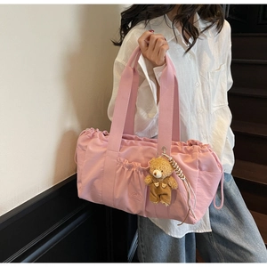 Pink canvas handbag with functional drawstring pockets and a cute teddy bear charm