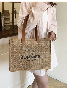 Large woven straw tote bag with brown leather handles and Summer palm tree print