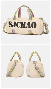 Detail view of beige cylindrical sports bag with SJCHAO logo and colorful woven straps