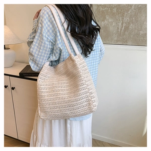 Close-up of beige woven tote bag showing detailed texture and large capacity design