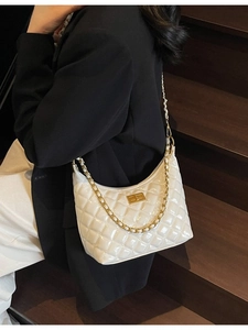 White quilted patent leather underarm bag with gold chain strap and turn-lock closure