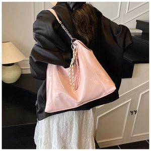 Pink embossed patent leather tote bag with silver chain strap and woven charm detail