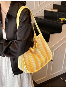 Striped mesh tote bag in yellow and white with leather straps for summer beach travel