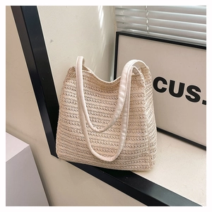 Close-up of cream woven tote bag with horizontal texture and matching dual handles
