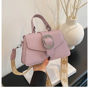 Detail der helllila Ledertasche mit Silberschnalle und ethnischem Bestickter Gurt