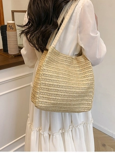 Minimalist straw woven tote bag for women with wide shoulder strap in natural beige color