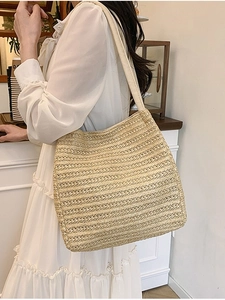 Large woven straw tote bag in beige for summer beach vacations and casual daily use