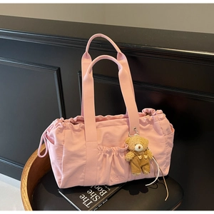 Pink canvas tote bag featuring drawstring closure, side pockets and cute bear charm