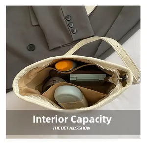 Detail of minimalist bucket bag showing large interior capacity and organized compartments