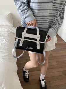 Chic black and white leather crossbody bag with top handle and large capacity