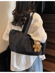 Minimalist black pleated canvas hobo bag with teddy bear pendant for women