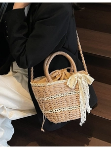 Handwoven straw bucket bag with floral lace bow and versatile shoulder straps for women