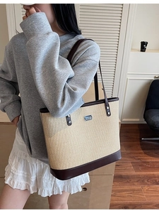 French style straw tote bag with brown leather trim and metallic logo detail
